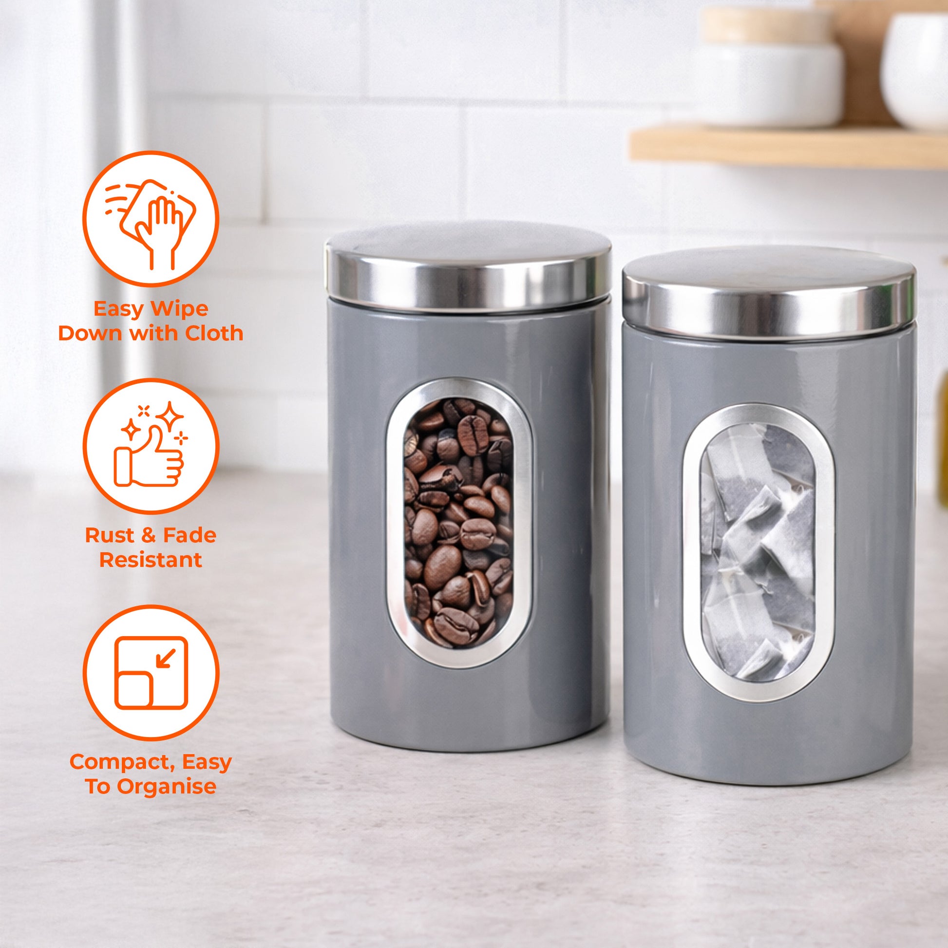 Two gray canisters with silver lids on a kitchen counter, featuring icons and text about their features.