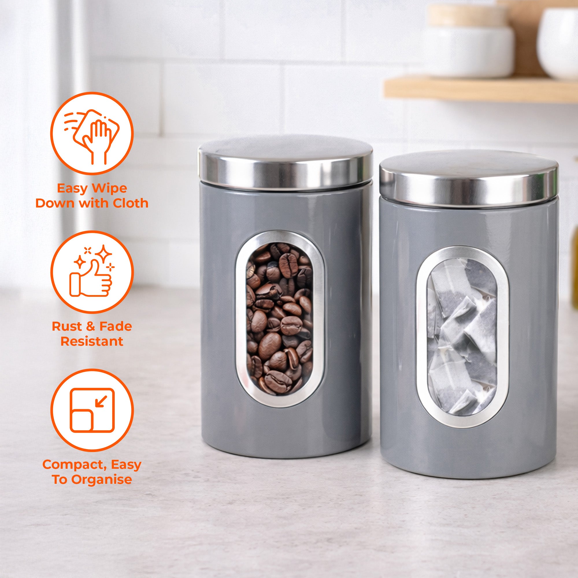 Two gray canisters with silver lids on a kitchen counter, featuring icons and text about their features.